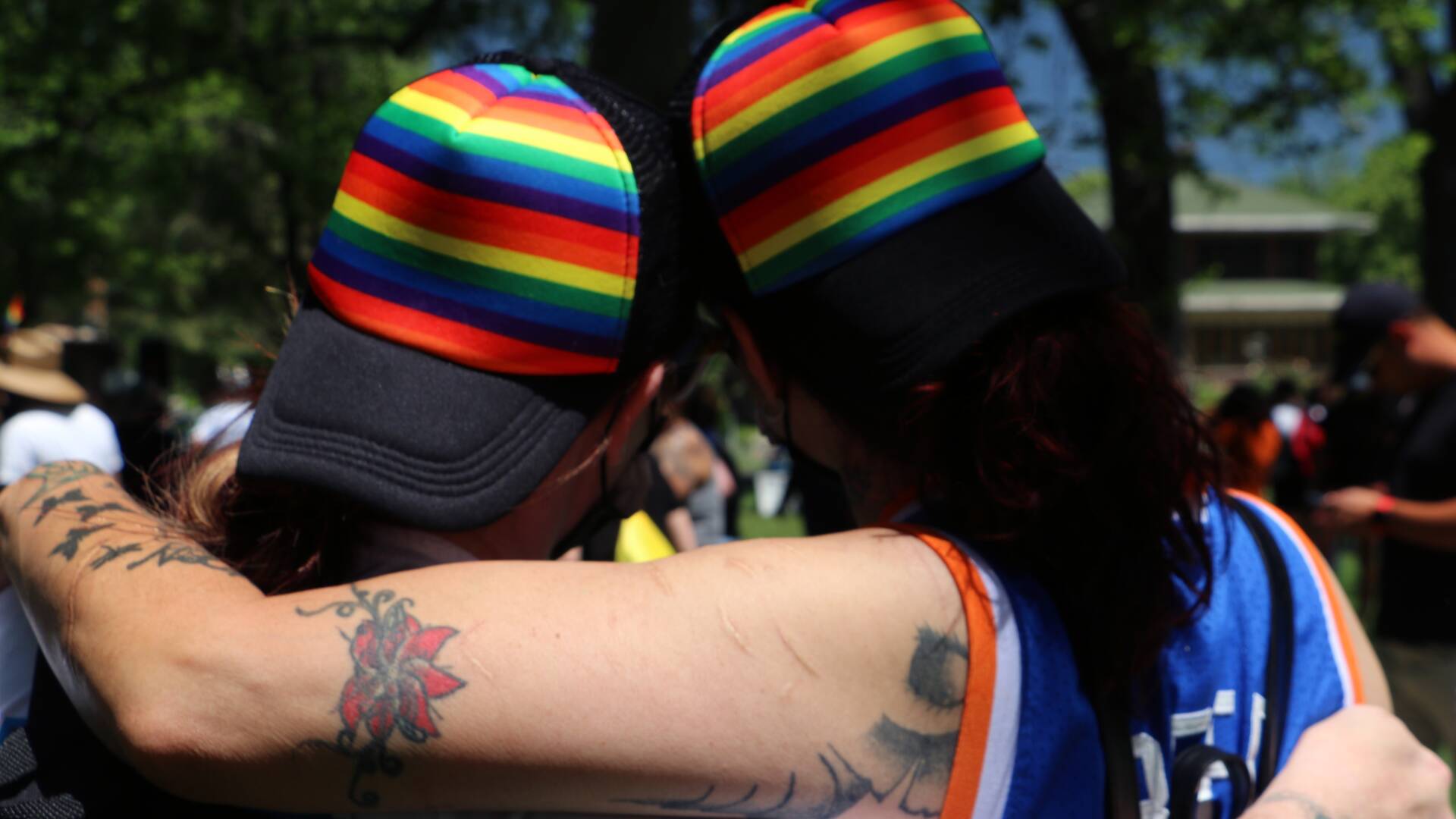 queer couple from behind at pride festival